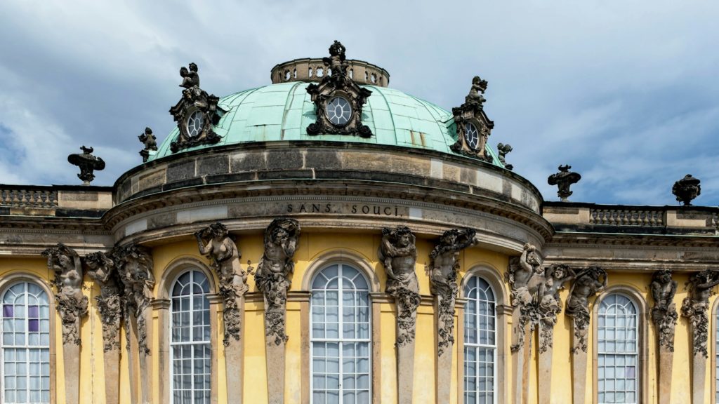 A large building with a green dome on top of it